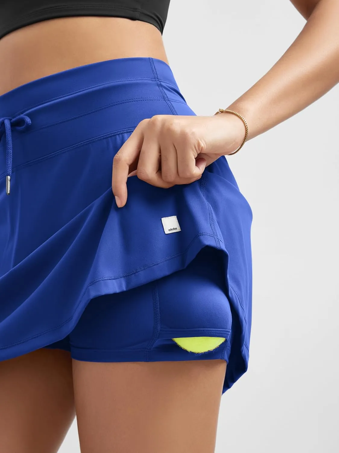 ODODOS Women's Drawstring Tie Daily Skirts Built-in Shorts Athletic Golf Tennis Skorts with Ball Pocket